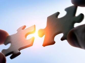 Piece of a jigsaw representing the concept of a merger